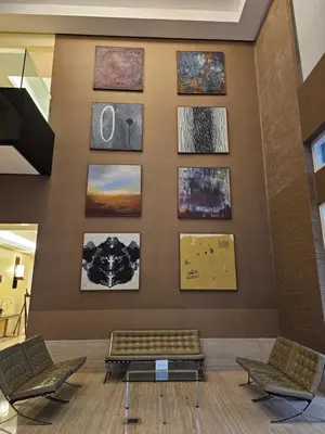 a waiting room with paintings on the wall at South of Market Private Residence in Manila