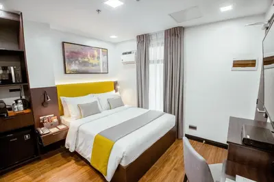 a hotel room with a bed and a television at ASN Boutique Residence in Manila