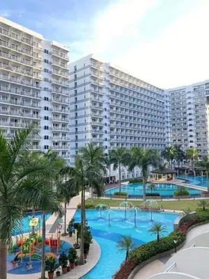 a resort with a large pool with a water park at Jam Staycation at Shell Residences in Manila