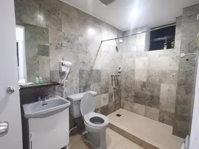 a bathroom with a toilet and a sink and a shower at Comfort Accommodation Services in Manila