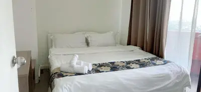 a bed with a stuffed animal sitting on top of it at Comfort room in Manila