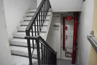 a set of stairs with a red fire hydrant at The Boni Tower by RSPL Manila City Center in Manila