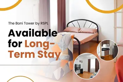 a room with a bed and a mirror at The Boni Tower by RSPL Manila City Center in Manila