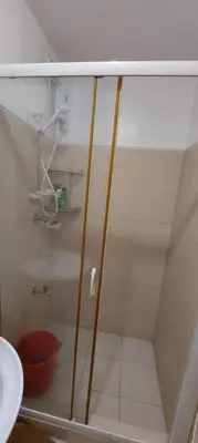a shower with a glass door in a bathroom at CHATEAU ELYSEE a7 near Airport and Sm mall in Manila