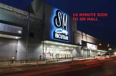 a building with a sign for a minute ride to sm mall at CHATEAU ELYSEE a7 near Airport and Sm mall in Manila
