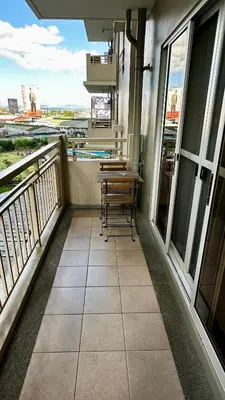 a balcony with a table and chairs on it at TresMariasCrib 3BR Unit at Pasig City Philippines in Manila