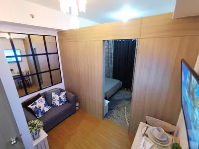 a small living room with a couch and a tv at Nathan's Pad @ Grace residences Nr. BGC in Manila