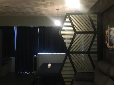 a room with a black curtain and a chair at Cozy Condo Near NAIA with WIFI, Pool and Balcony in Manila