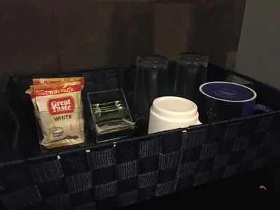 a black basket with food and other items on it at Cozy Condo Near NAIA with WIFI, Pool and Balcony in Manila