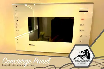 a microwave hanging on a wall with a sign at Luxurious 2 Bedroom Family Suite plus Maid Rm in Eastwood City in Manila