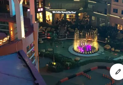 a view of a fountain in the middle of a building at Luxurious 2 Bedroom Family Suite plus Maid Rm in Eastwood City in Manila