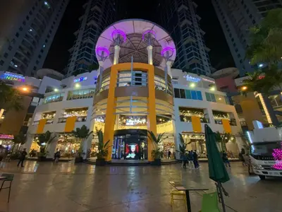 a large building in a city at night at Luxurious 2 Bedroom Family Suite plus Maid Rm in Eastwood City in Manila