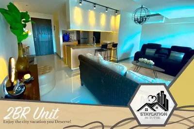 a rendering of a living room and kitchen at Luxurious 2 Bedroom Family Suite plus Maid Rm in Eastwood City in Manila