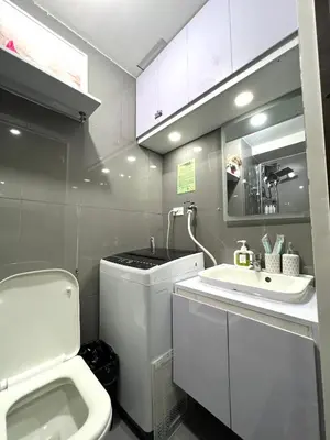 a small bathroom with a toilet and a sink at Apartment in Air Residences, Makati with wifi, Netflix, pool, mall and more in Manila