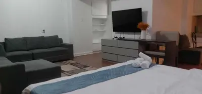 a living room with a couch and a tv at Accommodation services in Manila