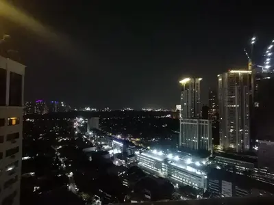 a view of a city at night with lights at Accommodation services in Manila