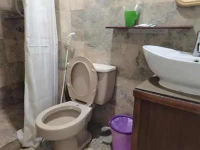 a bathroom with a toilet and a sink at Accommodation services in Manila