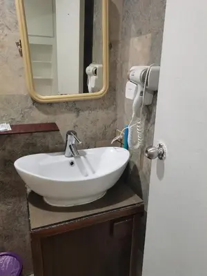 a bathroom with a white sink and a mirror at Accommodation services in Manila
