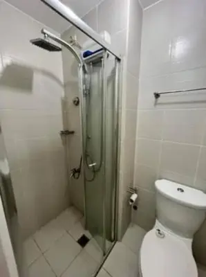 a bathroom with a shower and a toilet in it at BCP Homes in Manila