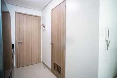 a hallway with a wooden closet and a door at Tatet Staycation Short Walk to SM MOA in Manila