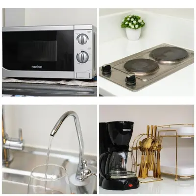 a kitchen with a microwave and a stove top oven at Newly Turned 0ver Cond0- Air Makati 1BR with Balcony in Manila