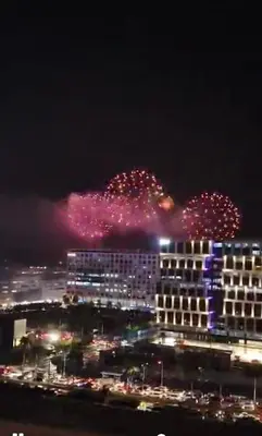 a view of a city at night with fireworks at Shore Residence condotel,Pasay city Philippines in Manila