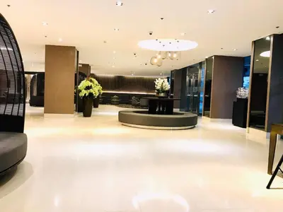 a lobby with a waiting room with flowers in it at Shore Residence condotel,Pasay city Philippines in Manila