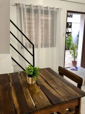 a wooden table with two potted plants on top of it at Sebastian’s Crib F in Dasmariñas