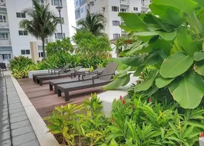 a row of benches in a park with plants at simple and affordable staycation at SHORE RESIDENCES in Manila