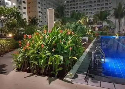 a resort with a swimming pool and some plants at simple and affordable staycation at SHORE RESIDENCES in Manila