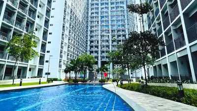 a swimming pool in a city with tall buildings at Sakan 5-Star Quality Condotel in Manila