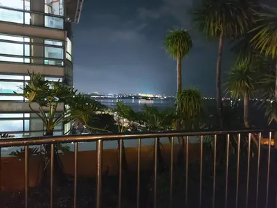 a view from the balcony of a building with palm trees at Grand Riviera Suites, US Embassy Comfy, Affordable Studio in Roxas Blvd, Ermita Manila in Manila