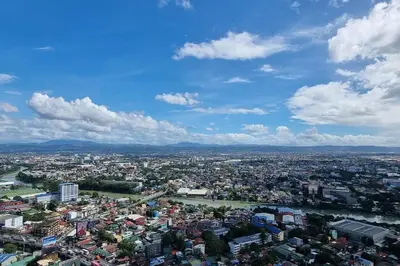 an aerial view of a city under a cloudy sky at A cozy 2 bedroom condo in Metro in Manila