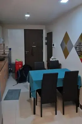 a dining room with a blue table and chairs at Kan Emilio Cozy 1BR Apartment in Makati in Manila