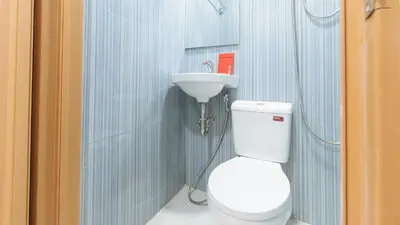 a bathroom with a toilet and a sink at RedDoorz @ El Grande Inn Santa Cruz Manila in Manila
