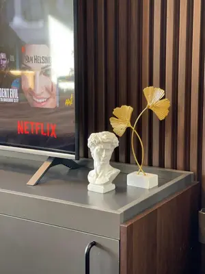 a vase on a table next to a tv at Muji-Inspired hōme-tél in the heart of Makati in Manila