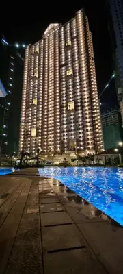 a large building with blue water in front of it at Apartment in Pasig in Manila