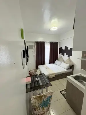 a small room with a bed and a table in it at JJMC HOMESTAY 36 With Netflix and Unli Wifi in Manila