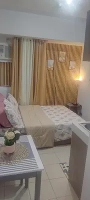 a hotel room with a bed and a table and a table sidx sidx at JJMC HOMESTAY 36 With Netflix and Unli Wifi in Manila