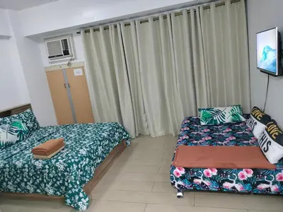 a small room with two beds and a window at CondoTel Pasay Newport City in Manila