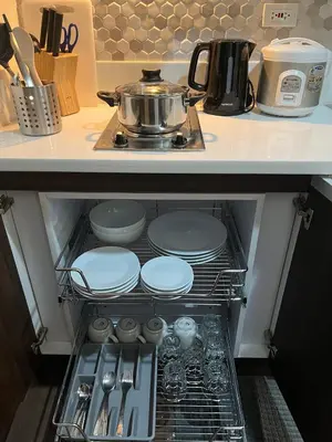 a drawer in a kitchen with dishes and a pot at Homey 1 Bedroom Unit at Air Residences in Manila