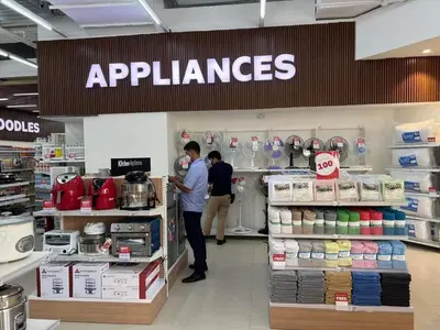 two people are standing in a appliance store at Homey 1 Bedroom Unit at Air Residences in Manila