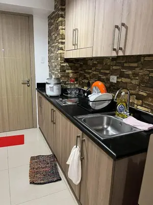 a kitchen with a sink and a counter top at Shore 1 Residences Staycation By Ms Chona in Manila