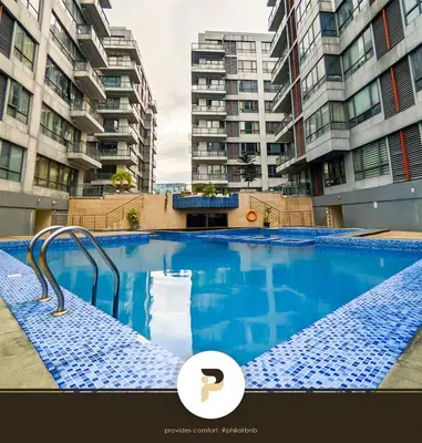 a swimming pool in front of some tall buildings at FULLY FURNISHED STUDIO NEAR MOA in Manila