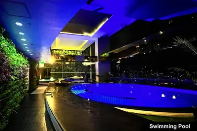 a swimming pool in a building with purple lights at the Gramercy Residences in Manila