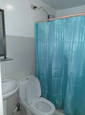 a bathroom with a toilet and a sink at La Casa Hungary 109 Kassel Residences Near NAIA in Manila