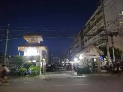 a building with a gazebo on a city street at night at La Casa Hungary 109 Kassel Residences Near NAIA in Manila