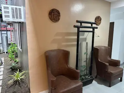 a room with two chairs and a fish tank at Aden Hotel in Manila