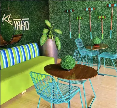 a room with two tables and chairs and plants at One bedroom Apartment with Netflix at Greenbelt Makati in Manila