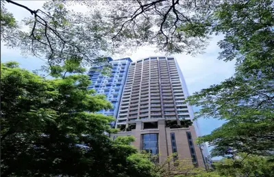a tall building with trees in front of it at One bedroom Apartment with Netflix at Greenbelt Makati in Manila